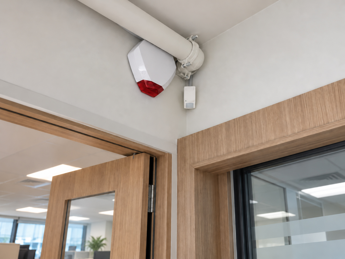 Red fire alarm call point on a corridor wall